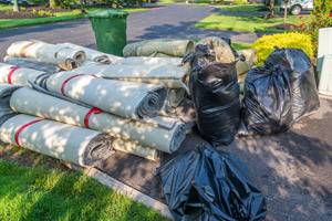 Pile of carpeting and carpet padding. Mike and Dad's Hauling provides expert carpet removal and carpet disposal services in Portland OR.