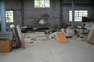 A messy commercial warehouse in need of clean out services. Contact Mike & Dad's Hauling to clean up your commercial property in Portland.