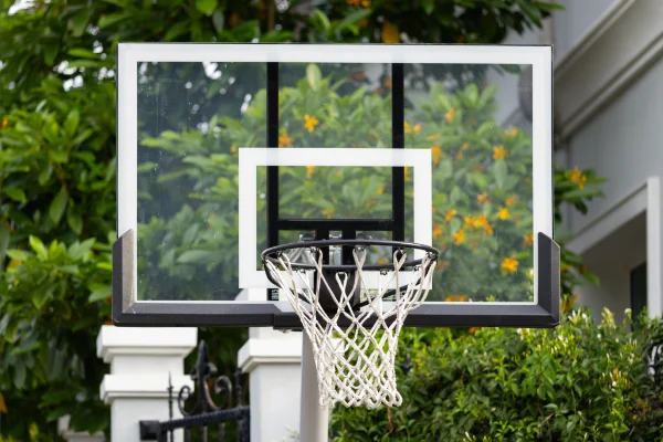 Neighborhood basketball hoop ready for removal by Mike & Dads Hauling.