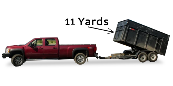 A red pickup truck with its large black dump bed raised for Mike & Dad's Hauling's 11 Yard Truck Loads.